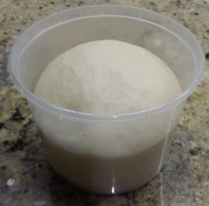 Pizza dough in container, ready for the fridge or left out if needed the same day.