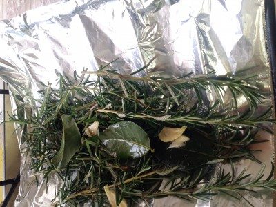 Herbs in the base of the roasting pan