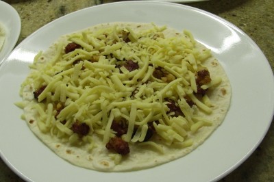 Chorizo mix and cheese ready for topping with a tortilla